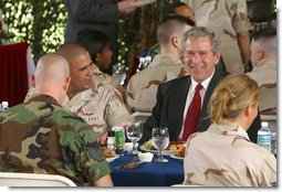 President George W. Bush sits down for lunch with military personnel at MacDill Air Force Base in Tampa, Florida, Wednesday, March 26, 2003.  White House photo by Paul Morse