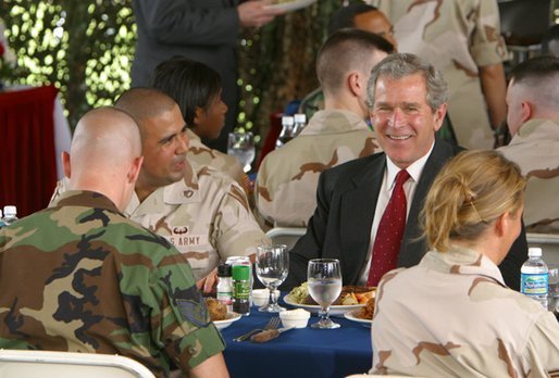 President George W. Bush sits down for lunch with military personnel at MacDill Air Force Base in Tampa, Florida, Wednesday, March 26, 2003. White House photo by Paul Morse