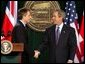 President George W. Bush and British Prime Minister Tony Blair shake hands after they conclude a joint news conference at the Camp David, March 27, 2003. "The United States and United Kingdom are acting together in a noble purpose. We're working together to make the world more peaceful; we're working together to make our respective nations and all the free nations of the world more secure; and we're working to free the Iraqi people," President Bush said. White House photo by Paul Morse