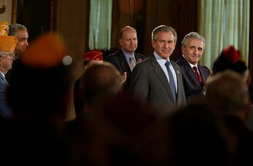 Standing with Secretary for Veterans Affairs Anthony Principi, right, President George W. Bush addresses national veterans service organizations in the East Room Friday, March 28, 2003. "Today's Armed Forces are upholding the finest traditions of our country and of our military. They are making great progress in the war in Iraq," said the President. "They are showing great courage and they are making this country proud." White House photo by Paul Morse.