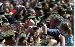 President George W. Bush greets Marines and their families after speaking at Camp Lejeune in Jacksonville, N.C., Thursday, April 3, 2003.  White House photo by Paul Morse