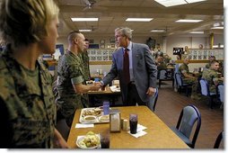 President George W. Bush greets Marines before sitting down with them for lunch at Camp Lejeune in Jacksonville, N.C., Thursday, April 3, 2003.  White House photo by Paul Morse