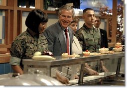 President George W. Bush and Mrs. Bush are served lunch with Marines at Camp Lejeune in Jacksonville, N.C., Thursday, April 3, 2003.  White House photo by Paul Morse