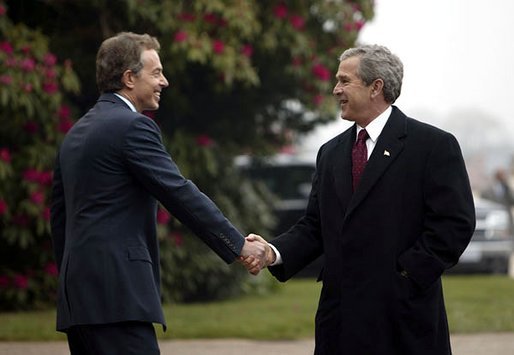 President George W. Bush is greeted by British Prime Minister Tony Blair at Hillsborough Castle near Belfast, Ireland, April 7, 2003. White House photo by Eric Draper.