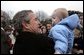Welcomed by an enthusiastic crowd, President George W. Bush holds a child during an airport arrival greeting at RAF Aldergrove airport in Northern Ireland, Monday, April 7, 2003. White House photo by Eric Draper.