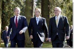 President George W. Bush walks with British Prime Minister Tony Blair, center, and Irish Prime Minister Bertie Ahern at Hillsborough Castle as he prepares to depart Northern Ireland Tuesday, April 8, 2003.   White House photo by Paul Morse