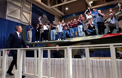 President George W. Bush walks to the stage as workers cheer during his introduction at the Boeing F-18 Production Facility in St. Louis, Mo., Wednesday, April 16, 2003. White House photo by Eric Draper.