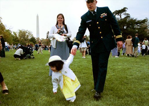 A tiny Easter egg toddler leads the charge at the White House Easter Egg Roll Monday, April 21, 2003. About 12,000 U.S. military families came to the South Lawn to race with Easter Eggs, play games, and listen to children's stories.