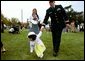 A tiny Easter egg toddler leads the charge at the White House Easter Egg Roll Monday, April 21, 2003. About 12,000 U.S. military families came to the South Lawn to race with Easter Eggs, play games, and listen to children's stories.