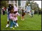 A helping hand is given during the Easter egg roll where little competitors use a spoon to carry a hard-boiled egg through the South Lawn race course and across the finish line at the White House Easter Egg Roll Monday, April 21, 2003. White House photo by Susan Sterner.
