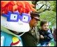 A United States Marine and her son stand for pictures with Chuckie, a character from the cartoon, "Rugrats," during the White House Easter Egg Roll Monday, April 21, 2003. More than 30 children's characters wandered through the South Lawn during the day's festivities, including Clifford the Big Red Dog, Winnie the Pooh and the Berenstain Bears.