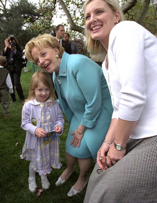 Visiting one-on-one with many families and children, Lynne Cheney poses for pictures on the South Lawn at the White House Easter Egg Roll Monday, April 21, 2003. White House photo by David Bohrer