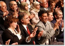 Standing at the far right, Haider Al-Jebori, President of the Steering Committee for Iraqi Home Culture, applauds for President George W. Bush at the Ford Community and Performing Arts Center in Dearborn, Mich., Monday, April 28, 2003.   White House photo by Tina Hager