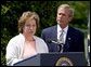 President George W. Bush listens to Betsy Rogers, 2003 National Teacher of the Year, in a ceremony in the East Garden Wednesday, April 30, 2003. Rogers is a 1st and 2nd grade teacher at Leeds Elementary School in Leeds, Ala. White House photo by Paul Morse