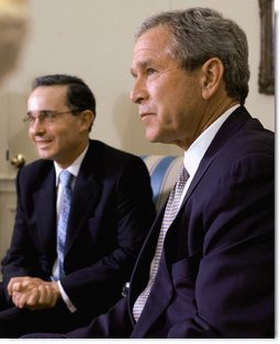 President George W. Bush and President of Colombia Alvaro Uribe take questions from the press in the Oval Office Wednesday, April 30, 2003.   White House photo by Tina Hager