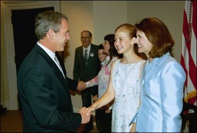 President George W. Bush greets Elizabeth Smart, center, and her mother Lois Smart in the Roosevelt Room Wednesday, April 30, 2003. President Bush met with the Smart family before the signing of the S. 151, PROTECT Act of 2003.  White House photo by Eric Draper White House photo by Eric Draper