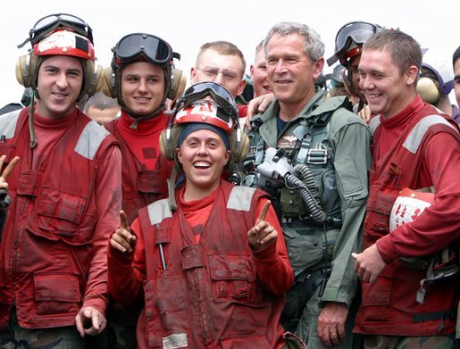 President George W. Bush poses with flight deck crew of the USS Abraham Lincoln May 1, 2003. White House photo by Paul Morse