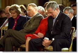 President George W. Bush and Laura Bush bow their heads in prayer during a ceremony marking today as the National Day of Prayer in the East Room Thursday, May 1, 2003. "Today we recognize the many ways our country has been blessed, and we acknowledge the source of those blessings. Millions of Americans seek guidance every day in prayer to the Almighty God. I am one of them," said the President in his remarks.  White House photo by Tina Hager