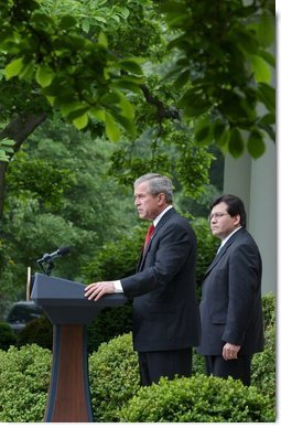 As Counsel Judge Alberto Gonzales stands by his side, President George W. Bush delivers remarks regarding his judicial nominations in the Rose Garden Friday, May 9, 2003.  White House photo by Tina Hager