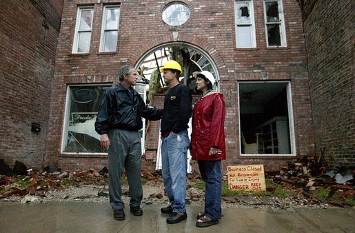 President George W. Bush comforts Scott and Annette Rector in front of their destroyed business in Pierce City, Mo., Tuesday, May 13, 2003. "You can't realize what it's like to see a tornado go right down the main street of a town and just wipe it out," said President Bush as he surveyed the damage from tornados that ripped through southwestern Missouri May 4. "It's hard to envision. But a lot of people know you're suffering, and a lot of people are praying for you, and a lot of people care for you. And a lot of people wish you all the best." White House photo by Susan Sterner