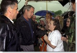 Listening to the story of how a tornado swept through their town, President George W. Bush meets one-on-one with residents during his walking tour of Pierce City, Mo., Tuesday, May 13, 2003.  White House photo by Susan Sterner