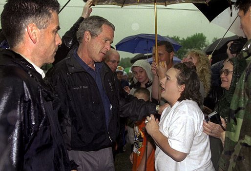 Listening to the story of how a tornado swept through their town, President George W. Bush meets one-on-one with residents during his walking tour of Pierce City, Mo., Tuesday, May 13, 2003. White House photo by Susan Sterner