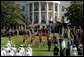 President George W. Bush and President Gloria Arroyo of the Philippines watch the Fife and Drum Corps march across the South Lawn during the State Arrival Ceremony Monday, May 19, 2003. White House photo by Lynden Steele.