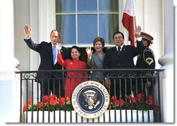 At the end of the ceremony, President Bush, Mrs. Bush, President Arroyo and Mr. Arroyo wave from the Truman Balcony.   White House photo by Eric Draper
