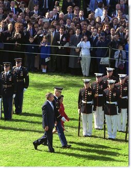 President George W. Bush and President Arroyo review the troops.   White House photo by Paul Morse