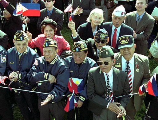 World War II Filipino-American veterans cheer for Presidents Bush and Arroyo. "I am proud of the contributions that Filipinos and Filipino Americans make to the American economy and society," said President Arroyo in her remarks. "In a quiet, but equally substantive way, we can compare it to the contribution made by Philippine World War II veterans to the defense of our common freedom and security." White House photo by Tina Hager