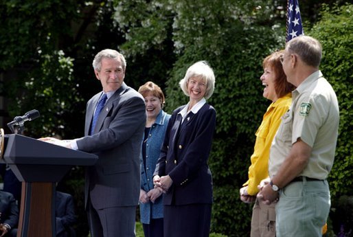 President George W. Bush discusses his plan for wildfire prevention and forest stewardship, the Healthy Forests Initiative, in The East Garden Tuesday, May 20, 2003. Standing on stage with the President are, from left, Agriculture Secretary Veneman, Interior Secretary Gale Norton, Fire Management Officer Andrea Gilham and Wildlife and Fire Staff Officer Rex Mann. White House photo by Susan Sterner.