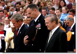 President George W. Bush, Major General James T. Jackson and Secretary of Defense Donald H. Rumsfeld (right) observe a 30-second moment of silence after a wreath-laying ceremony at the Tomb of the Unknown Soldier at Arlington National Cemetery on Memorial Day. Monday, May 26, 2003.  White House photo by Tina Hager