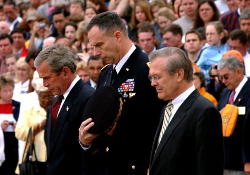 President George W. Bush, Major General James T. Jackson and Secretary of Defense Donald H. Rumsfeld (right) observe a 30-second moment of silence after a wreath-laying ceremony at the Tomb of the Unknown Soldier at Arlington National Cemetery on Memorial Day. Monday, May 26, 2003. White House photo by Tina Hager.