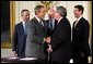 President George W. Bush shakes the hand of Congressman Bill Thomas, R-Calif., after signing the Jobs and Growth Tax Reconciliation Act of 2003 in the East Room Wednesday, May 28, 2003. Also pictured are, from left, Secretary of Commerce Donald Evans, Secretary of the Treasury John Snow and Senate Majority Leader Bill Frist, R-Tenn. White House photo by Eric Draper