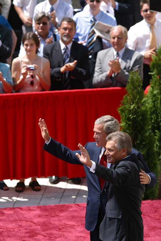 President George W. Bush and President of Poland Aleksander Kwasniewski acknowledge the audience following their speeches in the court yard of the Wawel Royal Palace in Krawkow, Poland, Saturday, May 31, 2003. White House photo by Paul Morse