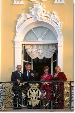 President George W. Bush and Mrs. Laura Bush wave with Russian President Vladimir Putin and wife Lyudmila Putin from the window of Peterhof Palace in St. Petersburg, Russia May 31, 2003. They were taking part in St. Petersburg's 300th anniversary celebration.  White House photo by Paul Morse