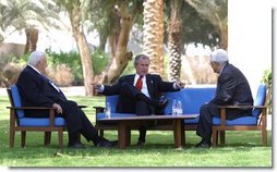 President George W. Bush, center, discusses the Middle East peace process with Prime Minister Ariel Sharon of Israel, left, and Palestinian Prime Minister Mahmoud Abbas in Aqaba, Jordan, Wednesday, June 4, 2003.   White House photo by Paul Morse