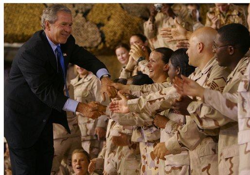 President George W. Bush greets troops during his introduction at Camp As Sayliyah in Doha, Qatar, Thursday, June 5, 2003. White House photo by Paul Morse
