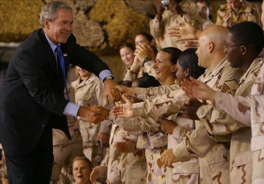 President George W. Bush greets troops during his introduction at Camp As Sayliyah in Doha, Qatar, Thursday, June 5, 2003. White House photo by Paul Morse