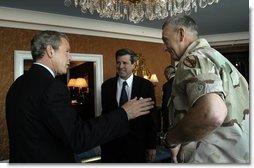 President George W. Bush discusses Iraqi reconstruction with Ambassador Paul Bremer, center, and General Tommy Franks in Doha, Qatar, Thursday, June 5, 2003.  White House photo by Eric Draper