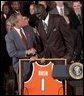 Congratulating the NCAA Winter Championship teams, President George W. Bush stands with Kueth Duany of Syracuse University's mens' basketball team in the East Room Tuesday, June 17, 2003. White House photo by Tina Hager