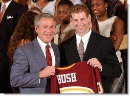 Congratulating the NCAA Winter Championship teams, President George W. Bush stands with Grant Potulny of the University of Minnesota-Twin Cities' men's hockey team in the East Room Tuesday, June 17, 2003.  White House photo by Tina Hager