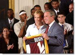 Congratulating the NCAA Winter Championship teams, President George W. Bush stands with Maria Roth of the University of Minnesota-Duluth's women's hockey team in the East Room Tuesday, June 17, 2003.  White House photo by Tina Hager