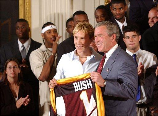 Congratulating the NCAA Winter Championship teams, President George W. Bush stands with Maria Roth of the University of Minnesota-Duluth's women's hockey team in the East Room Tuesday, June 17, 2003. White House photo by Tina Hager
