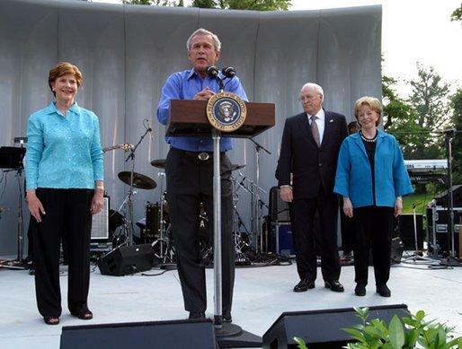President George W. Bush shares the stage with Laura Bush, Vice President Dick Cheney and Lynne Cheney as he welcomes members of Congress and their families to the Congressional Picnic on the South Lawn Wednesday, June 18, 2003. White House photo by Susan Sterner
