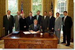 President George W. Bush signs S. 342, the Keeping Children and Families Safe Act of 2003, in the Oval Office Wednesday, June 25, 2003. The act reauthorizes the Child Abuse Prevention and Treatment Program and other related programs.  White House photo by Susan Sterner