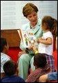 Laura Bush reads the book "That's My Dog" to students from the Clayton Center, a migrant Head Start Program, at the Raleigh Durham Airport in Raleigh, N.C. Friday, July 18, 2003. Mrs. Bush presented each child a book to help encourage reading and school readiness. White House photo by Tina Hager