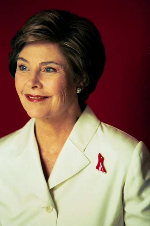 Laura Bush wears the Red Dress Pin to call attention to "The Heart Truth" campaign during a portrait session at the White House July 1, 2003. White House photo by Susan Sterner.
