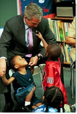 During a tour of Highland Park Elementary School in Landover, Md., President George W. Bush plays with children at the school's Head Start Center where he discussed strengthening America's Head Start Program Monday, July 7, 2003.  White House photo by Paul Morse
