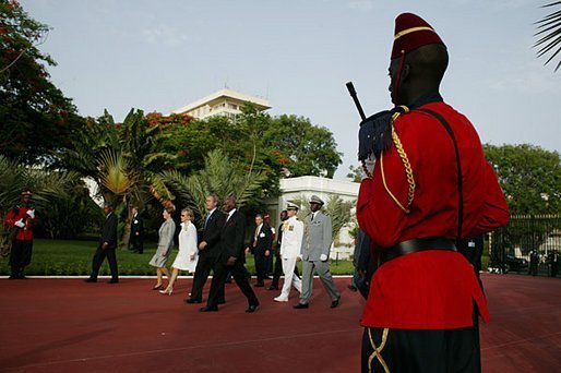 President George W. Bush and Laura Bush join President Abdoulaye Wade his wife, Viviane Wade, of Senegal in a welcoming ceremony at the Presidential Palace in Dakar, Senegal, Tuesday morning, July 8, 2003. White House photo by Paul Morse